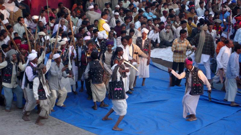 Tribal devotees rejoice by dancing and singing kirtans