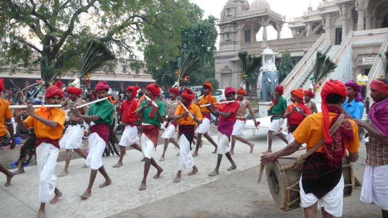 Tribal devotees dance in traditional clothes
