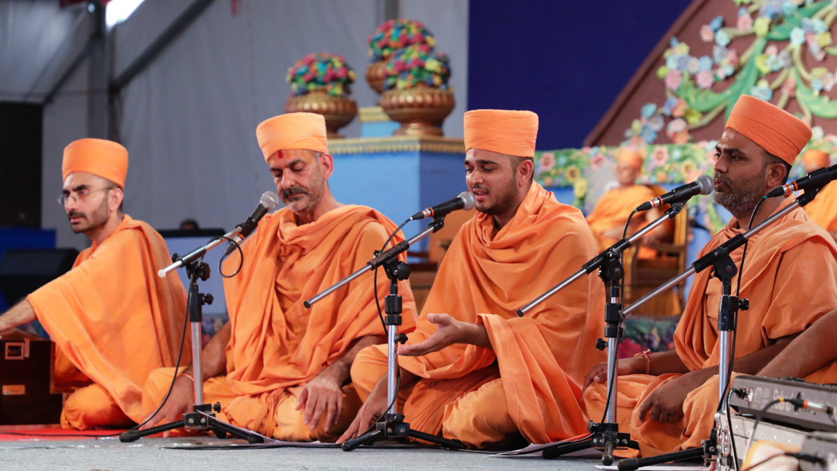 Sadhus sing kirtans at the beginning of the celebration assembly