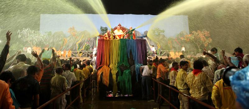  Swamishri showers sanctified colored water on devotees 