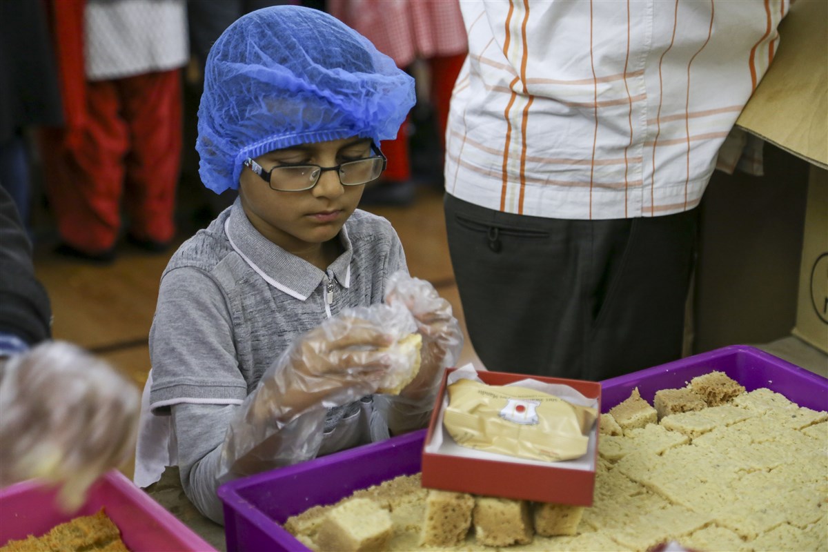 Volunteers prepare prasad boxes for visitors