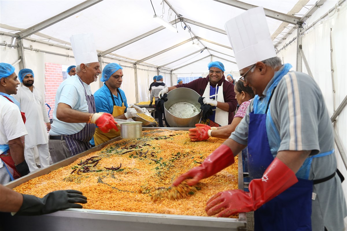 Volunteers prepare chevdo for prasad