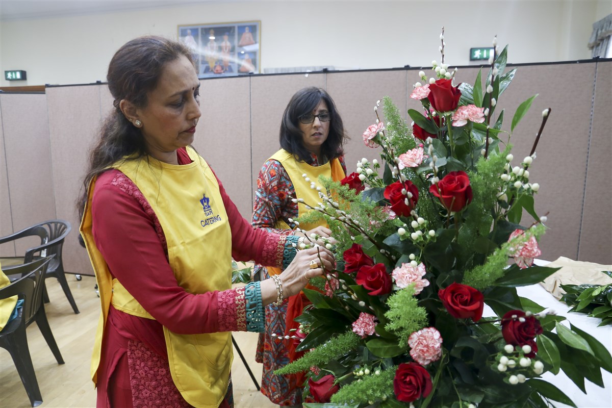 Volunteers prepare the floral arrangements