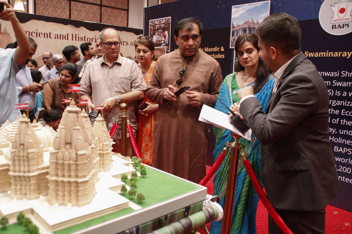 A volunteer guides visitors through the exhibition
