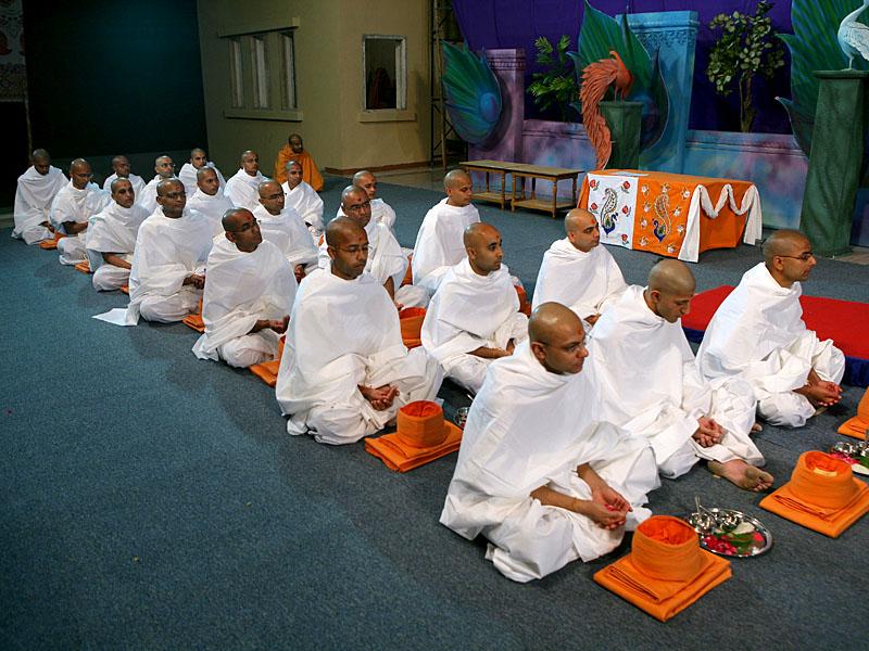 Prior to Swamishri's morning puja Pujya Mahant Swami is engaged in diksha rituals of parshads and sadhaks 