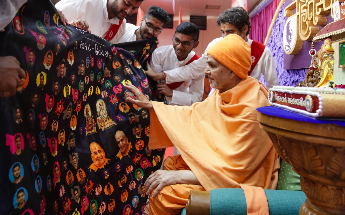 Swamishri sanctifies a shawl