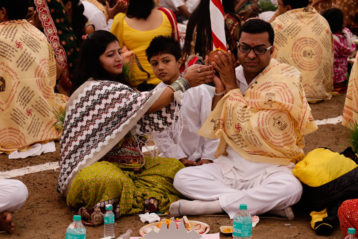 Devotees participate in yagna rituals