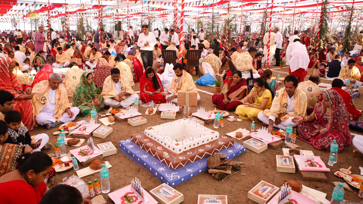 Devotees participate in yagna rituals