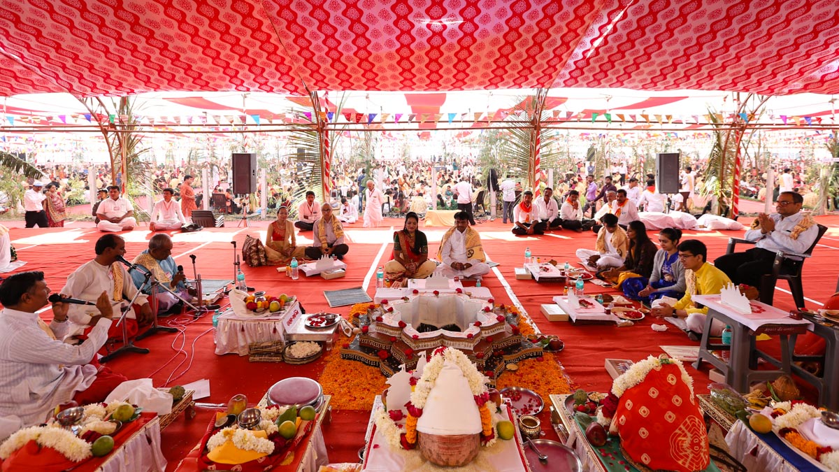Devotees participate in yagna rituals