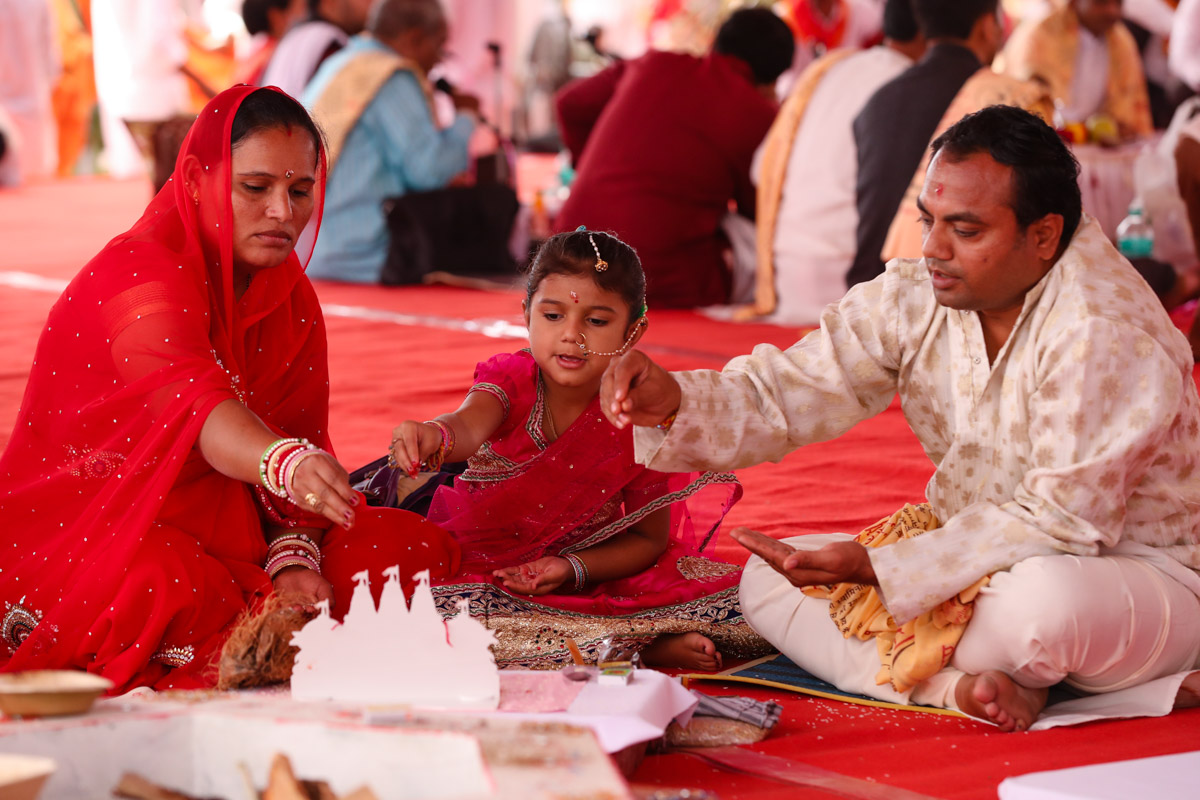 Devotees participate in yagna rituals