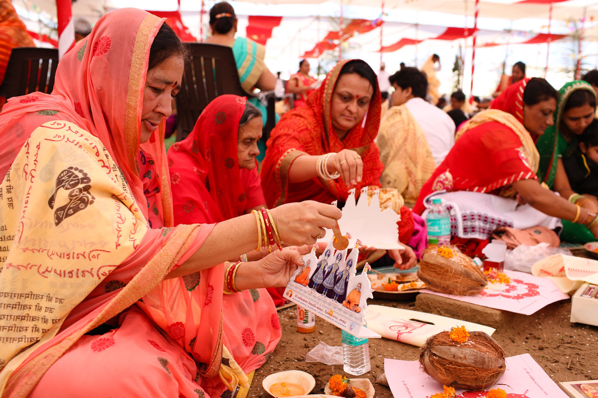 Devotees participate in yagna rituals