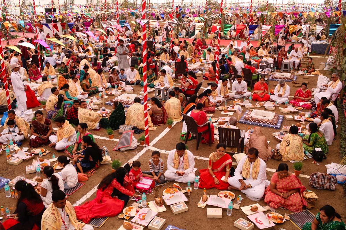 Devotees participate in yagna rituals