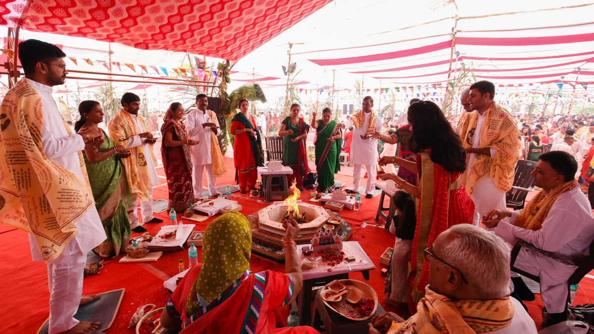 Devotees participate in yagna rituals