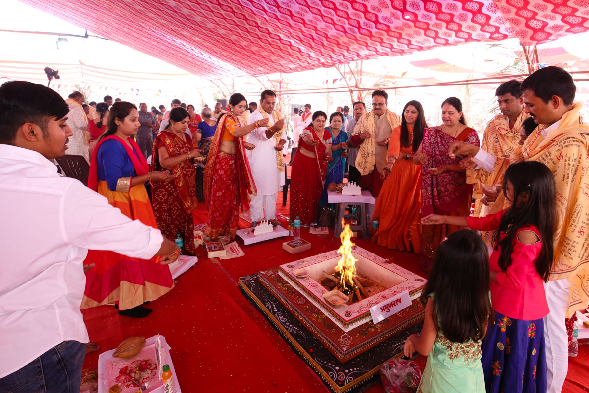 Devotees participate in yagna rituals