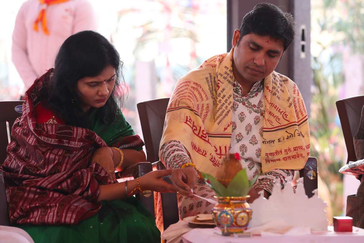 Devotees participate in yagna rituals
