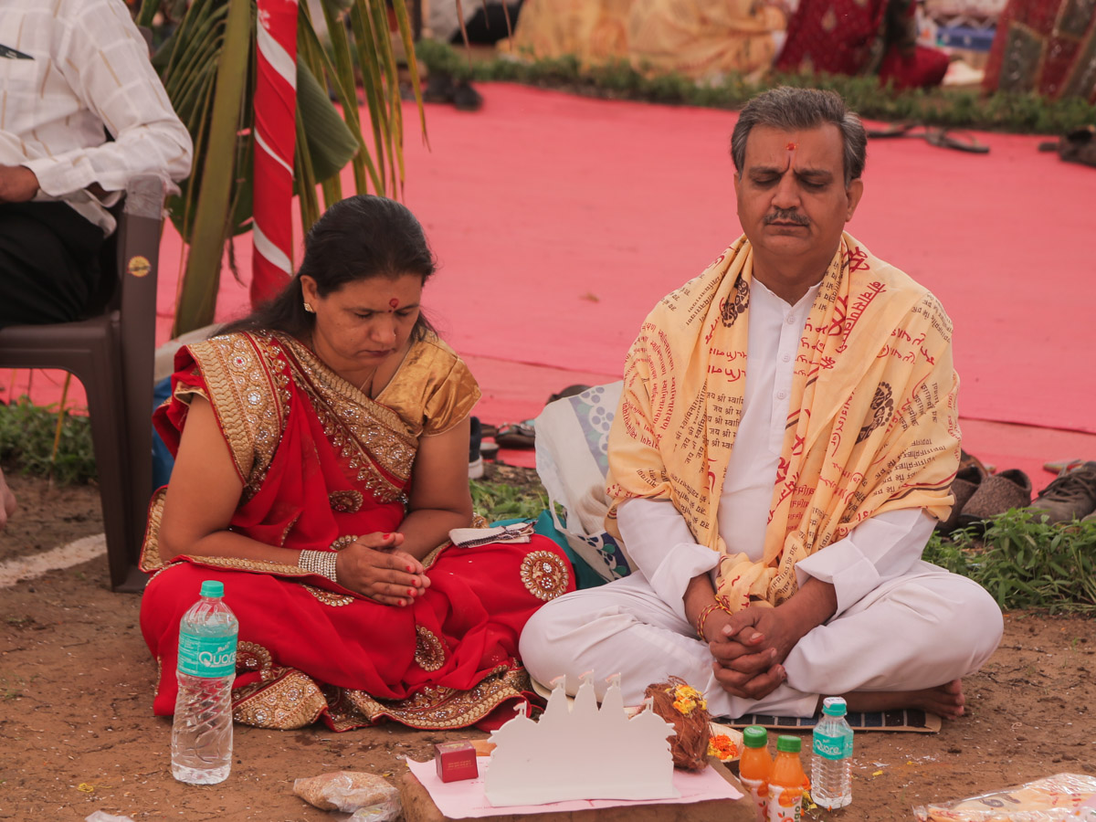 Devotees participate in yagna rituals
