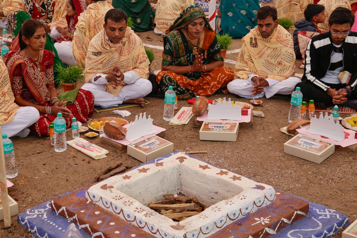 Devotees participate in yagna rituals