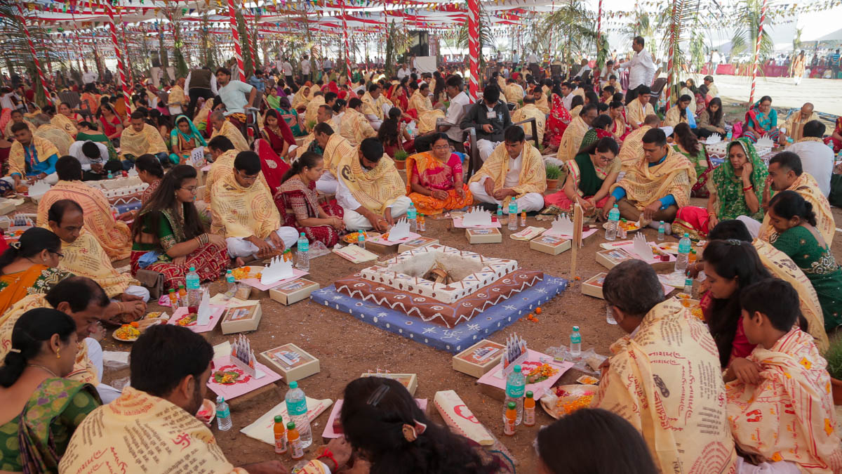 Devotees participate in yagna rituals