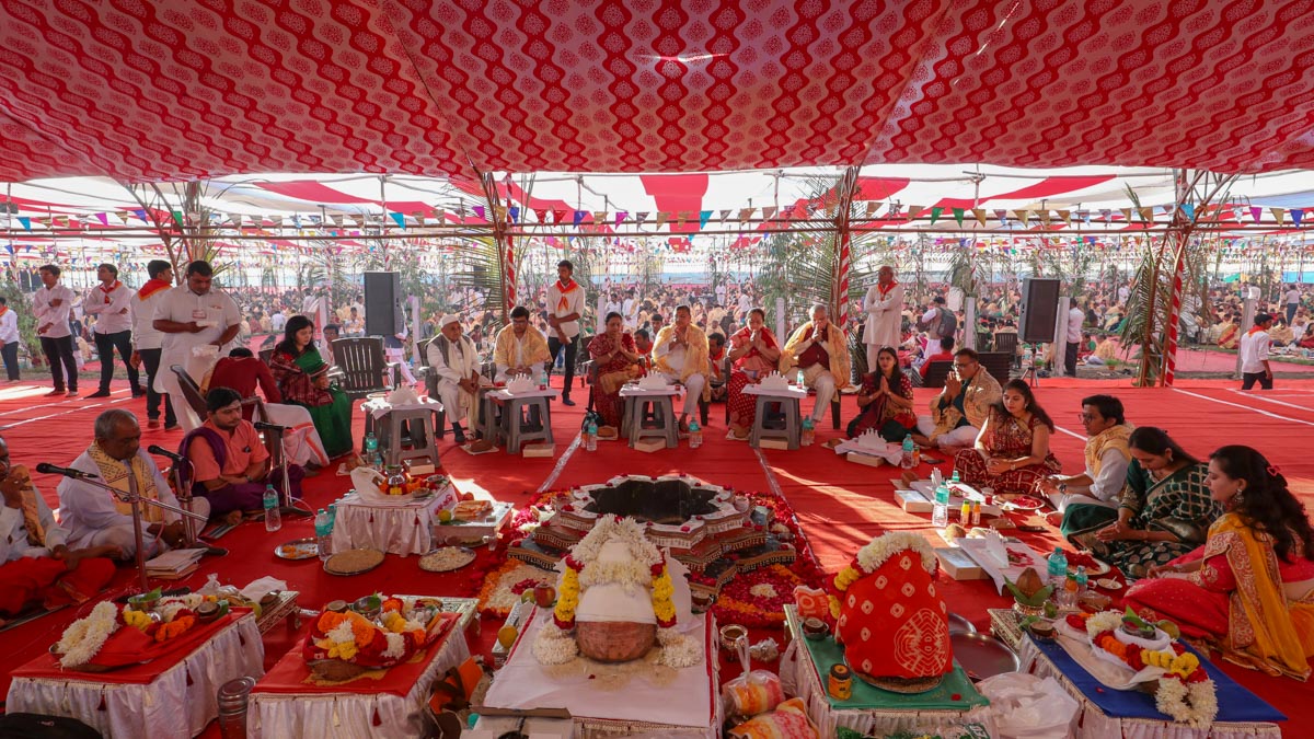 Devotees participate in yagna rituals