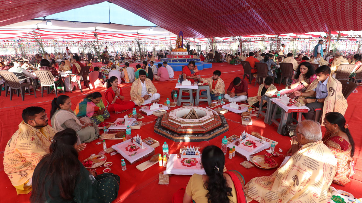 Devotees participate in yagna rituals