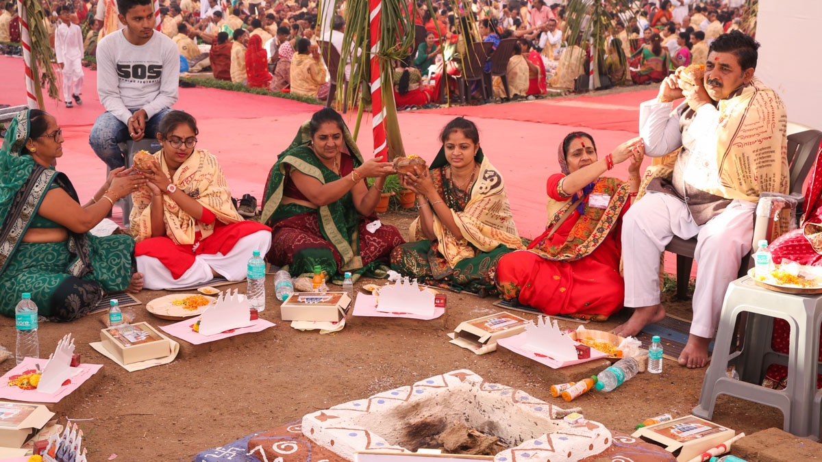Devotees participate in yagna rituals