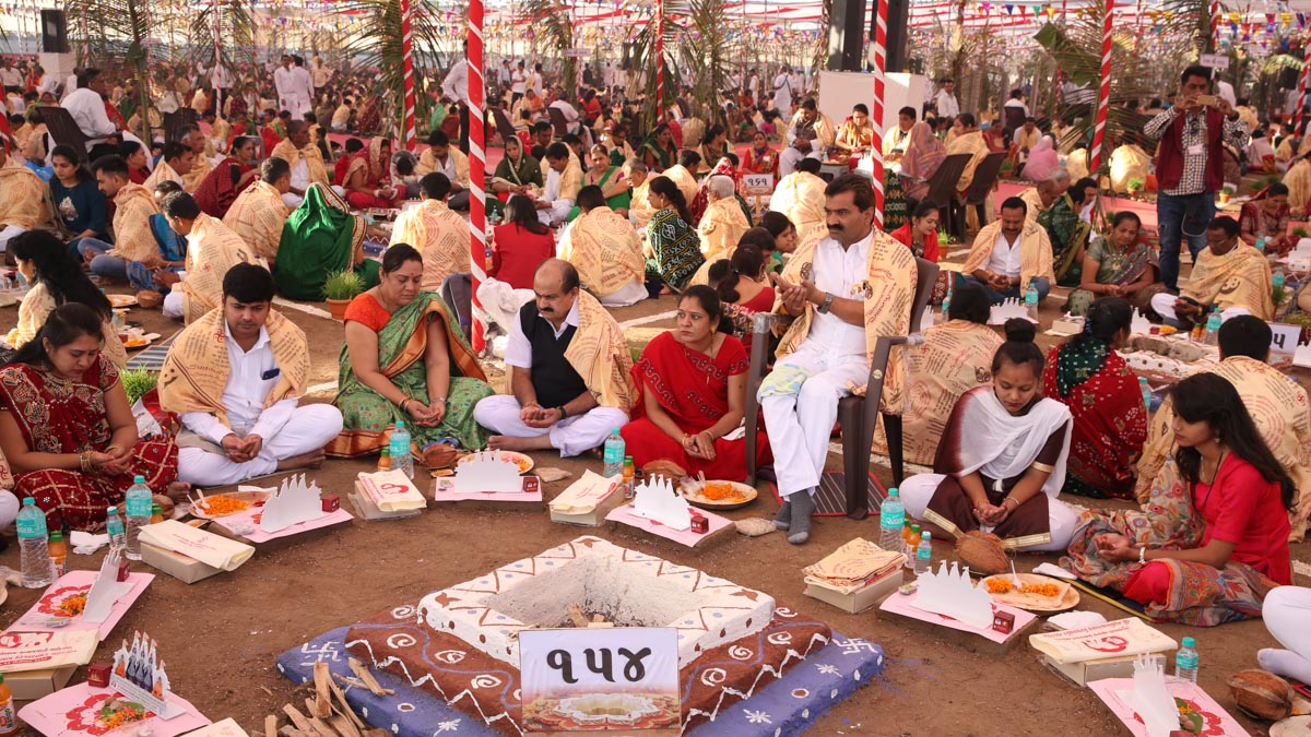 Devotees participate in yagna rituals