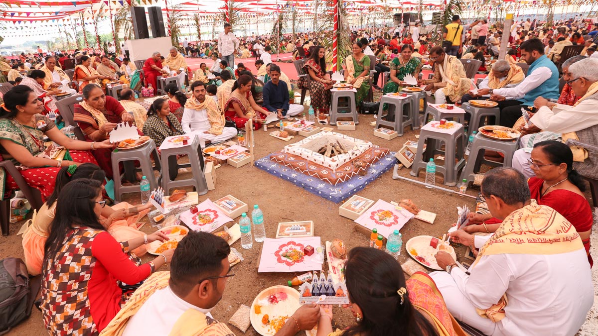 Devotees participate in yagna rituals