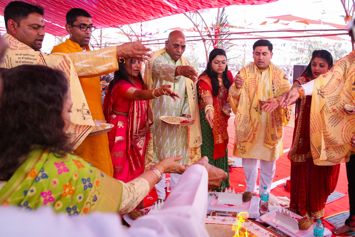 Devotees participate in yagna rituals