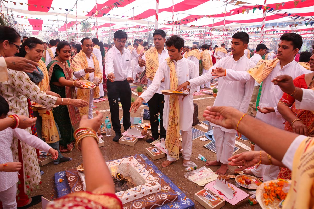 Devotees participate in yagna rituals