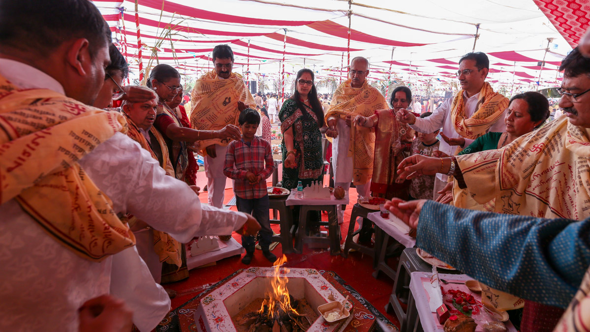 Devotees participate in yagna rituals