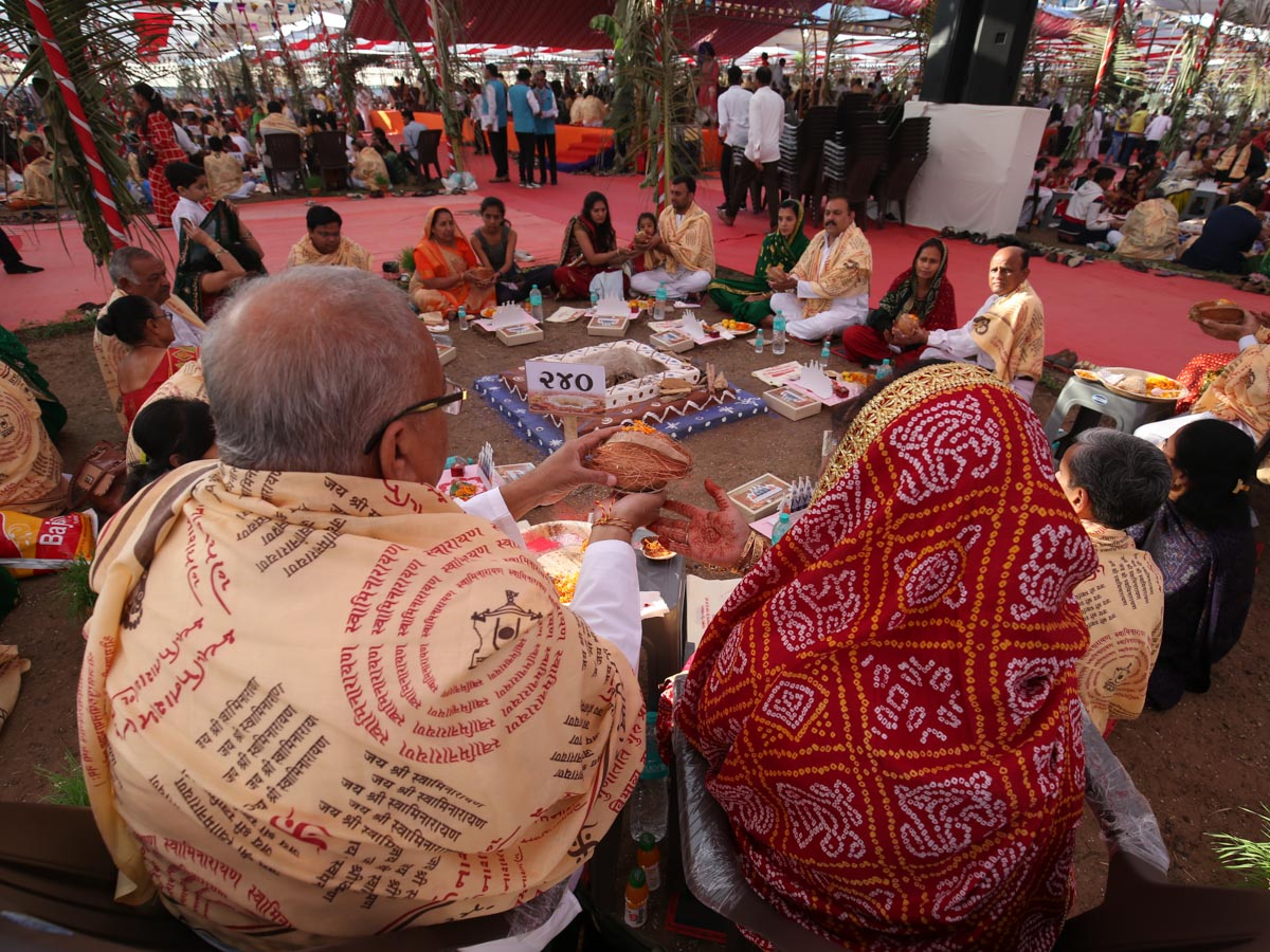 Devotees participate in yagna rituals