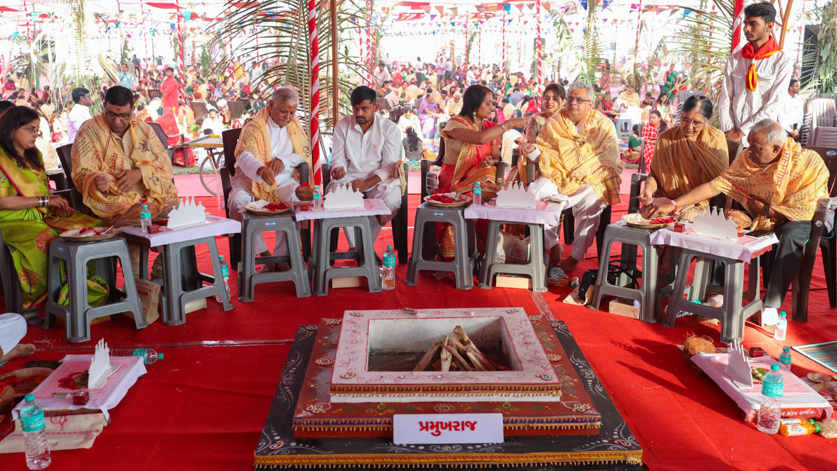 Devotees participate in yagna rituals