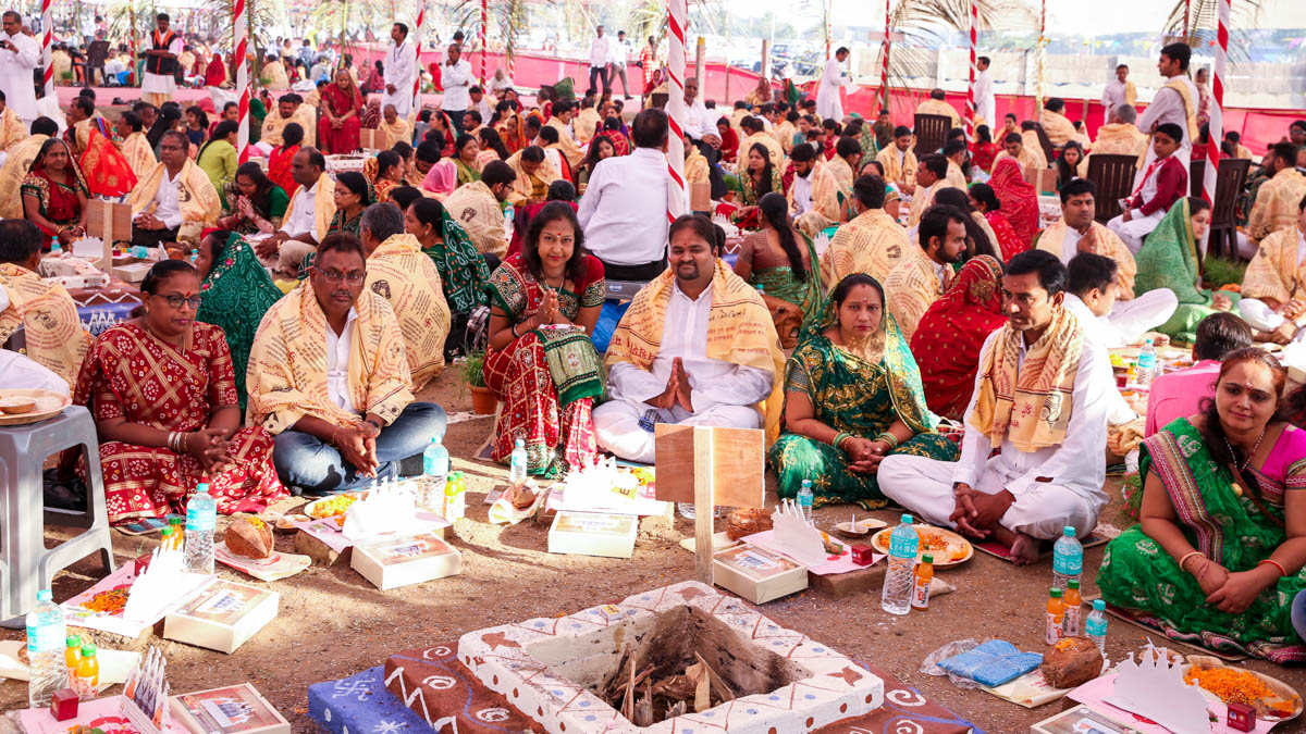 Devotees participate in yagna rituals