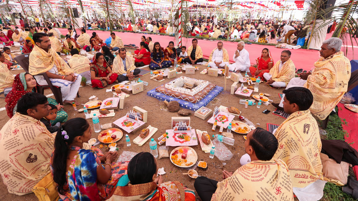 Devotees participate in yagna rituals
