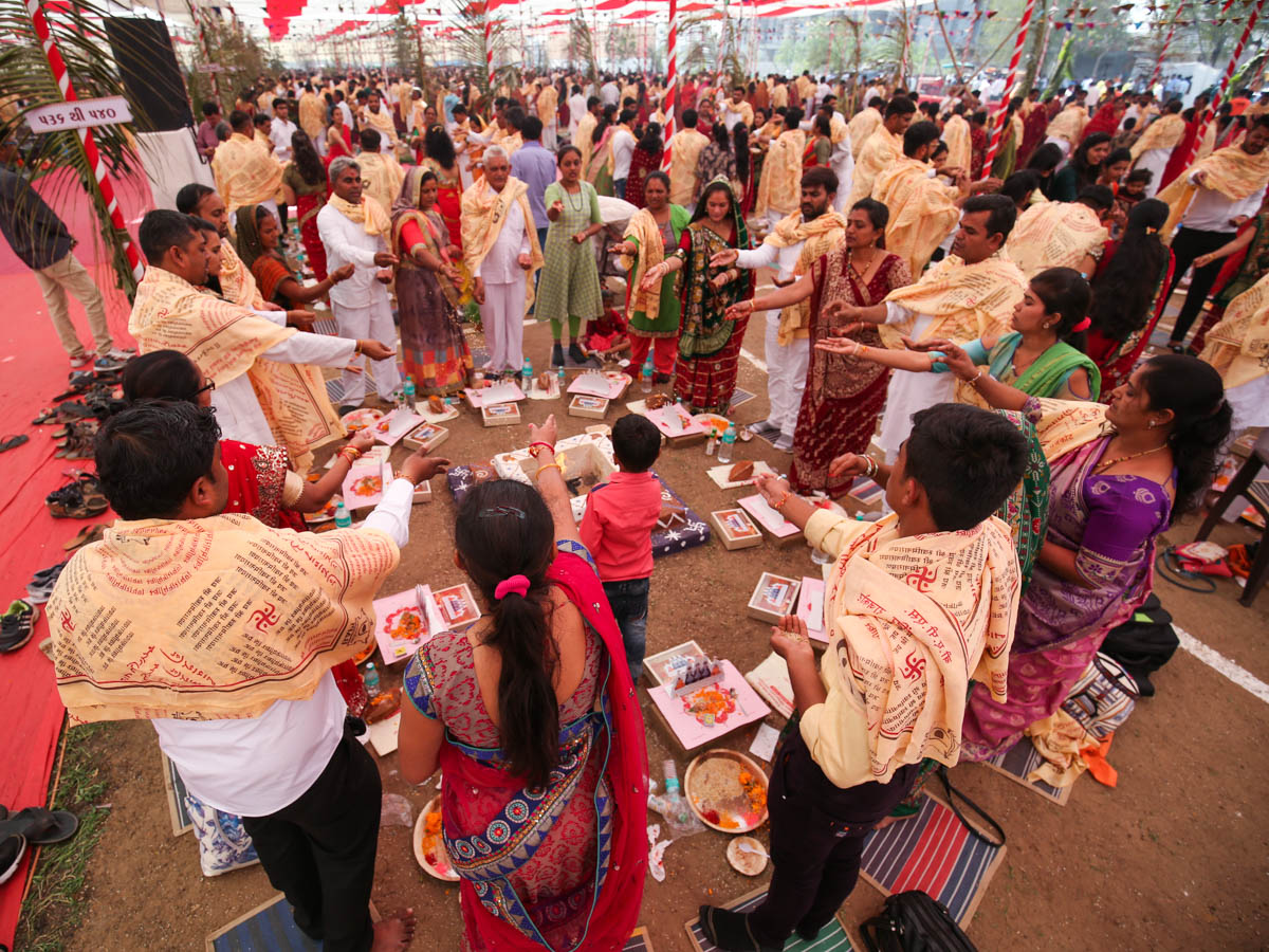 Devotees participate in yagna rituals