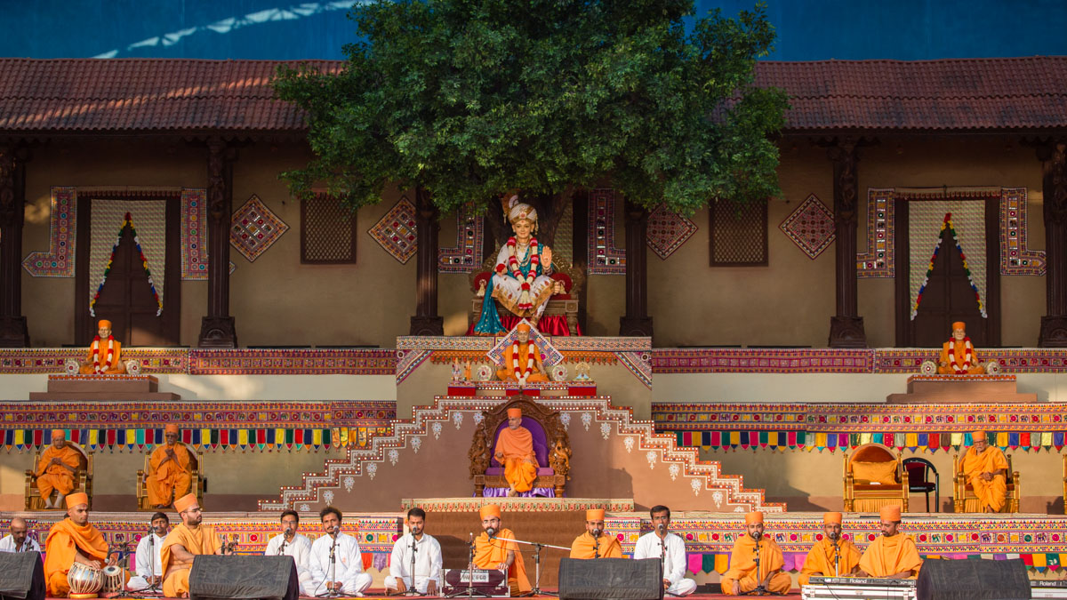 Sadhus and youths sing kirtans in the assembly