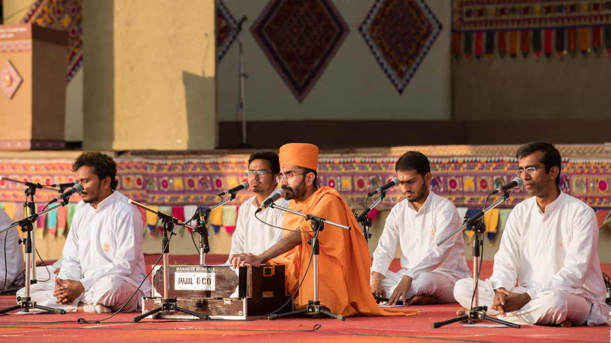 Sadhus and youths sing kirtans in the assembly