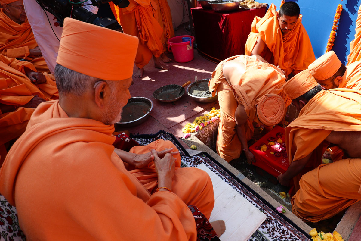 Sadhus place the main shila in the foundation pit