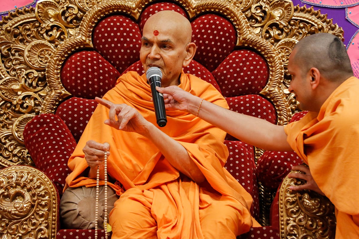 Swamishri converses with a child