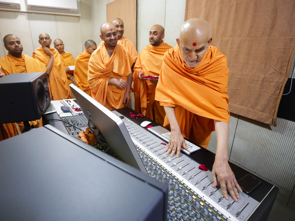 Swamishri sanctifies the audio mixer in the recording studio