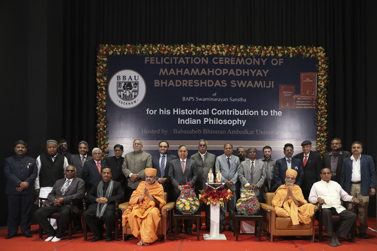 Deputy Chief Minister and university representatives with Narayanmuni Swami and Bhadresh Swami