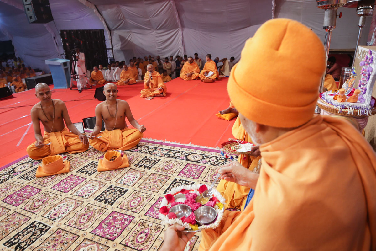 Swamishri leads the diksha rituals the parshads to be initiated as sadhus perform 