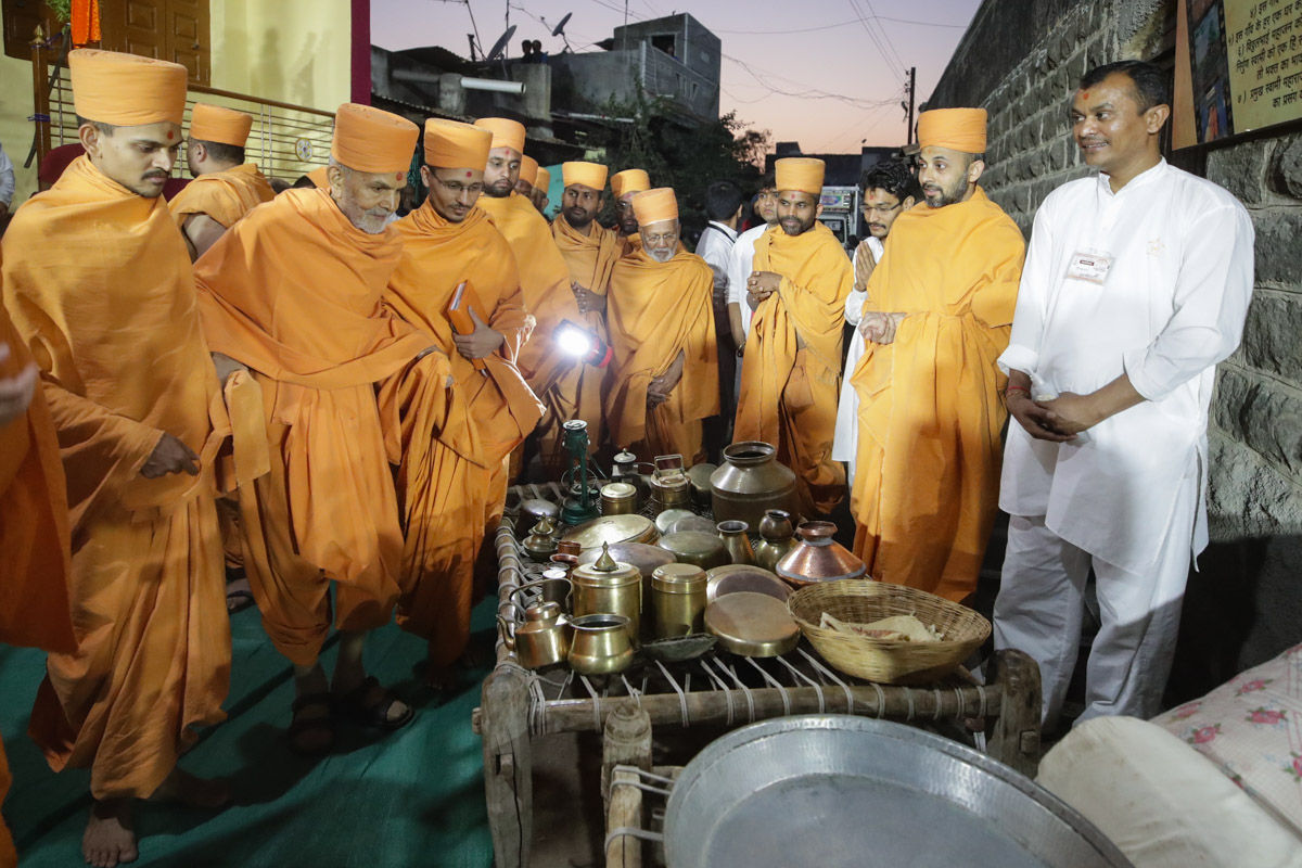 Swamishri views the utensils used and sanctified by Brahmaswarup Shastriji Maharaj
