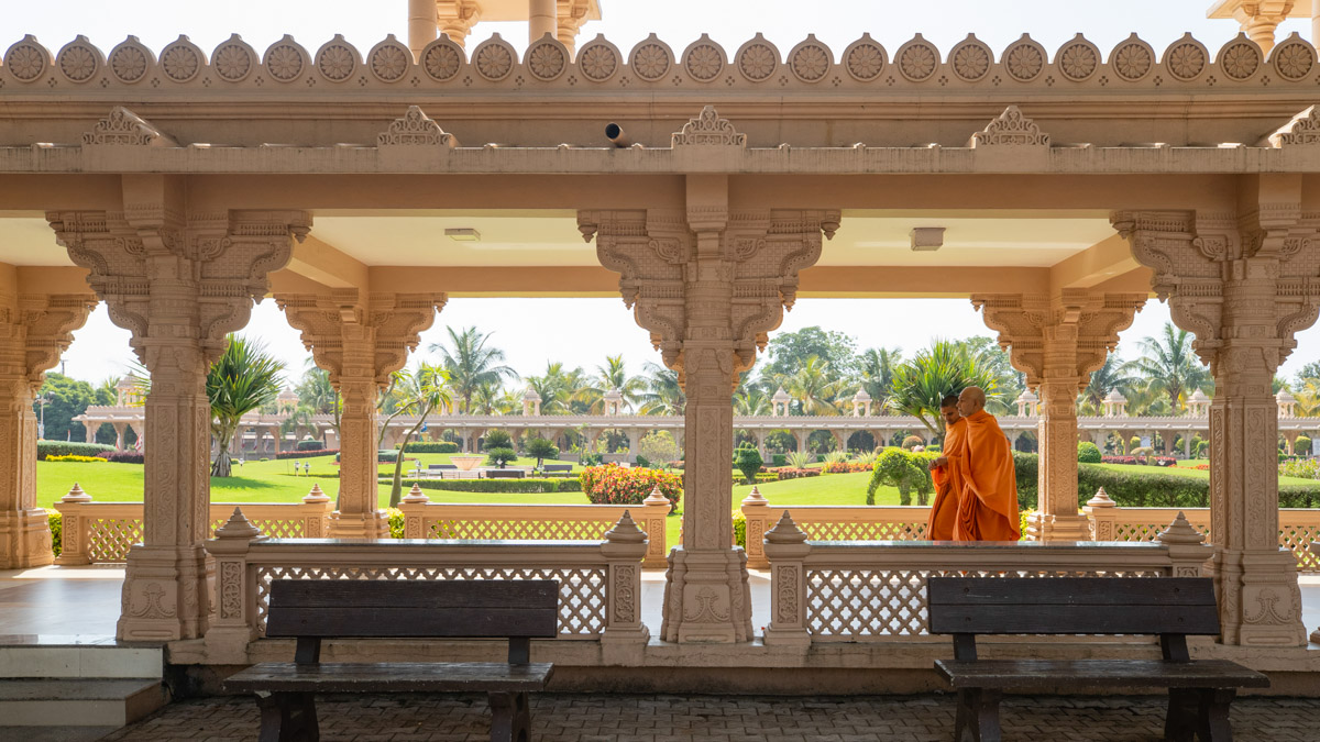 Swamishri performs his evening walk in the mandir colonnade