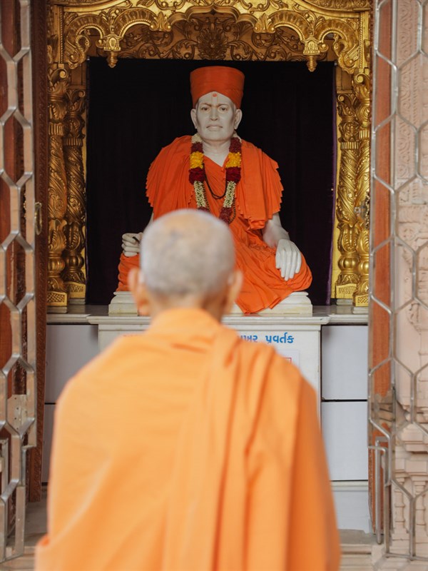 Swamishri engrossed in darshan of Brahmaswarup Shastriji Maharaj before he departs from Sankari