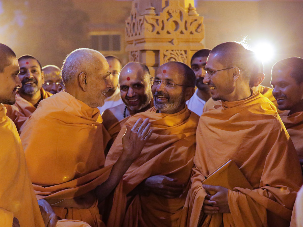 Swamishri converses with sadhus in the mandir pradakshina