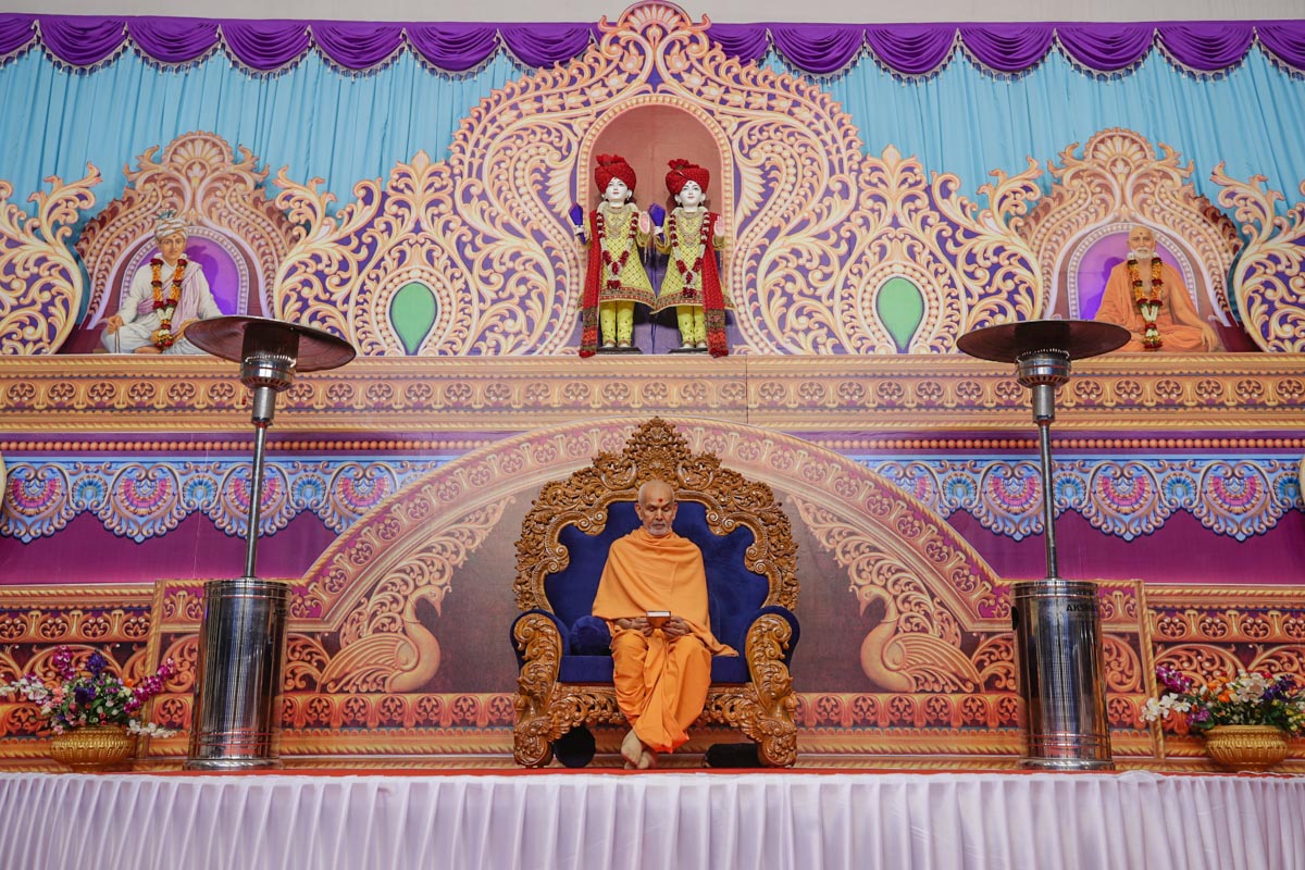 Swamishri reads the Shikshapatri at the conclusion of his puja