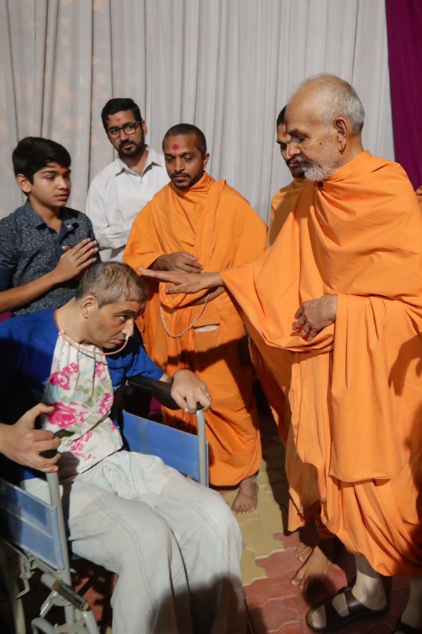 Swamishri blesses an ailing devotee