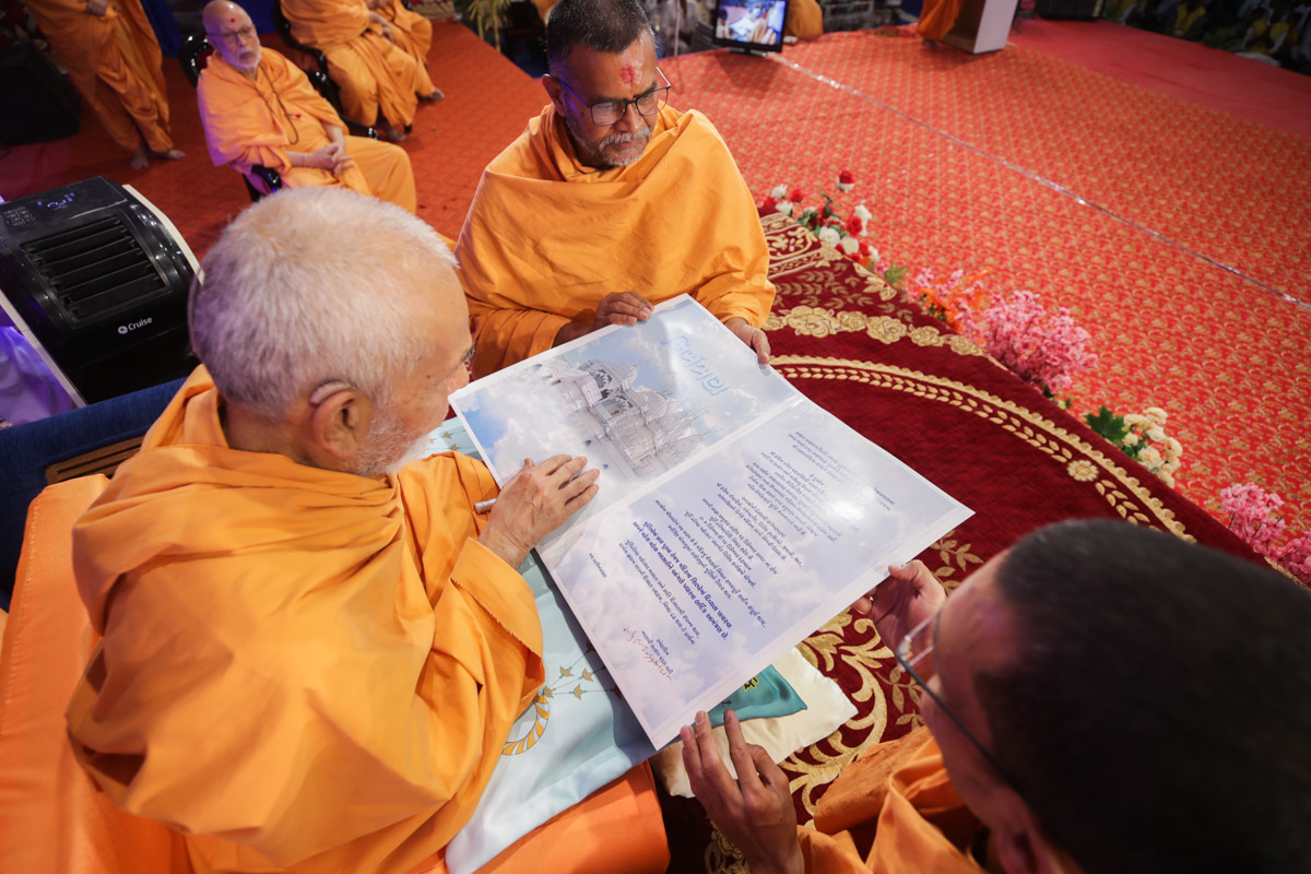 Sadhus present Swamishri the invitation for Navsari mandir murti-pratishtha celebrations