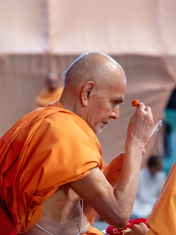 Swamishri applies chandlo on his forehead